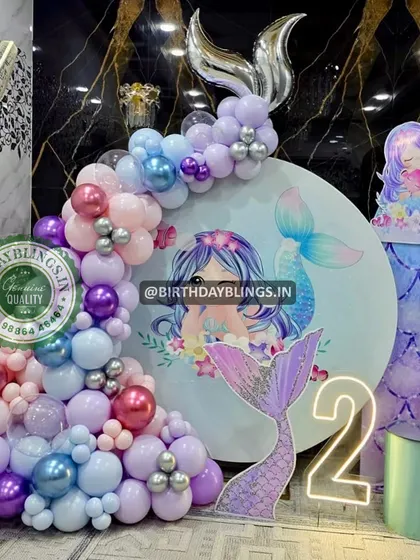 Another detail shot of the glamorous mermaid party, focusing on the mermaid tail cutout and neon sign.