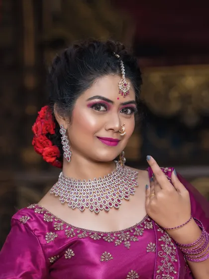 A close-up portrait that highlights the intricate design of the diamond and ruby necklace.