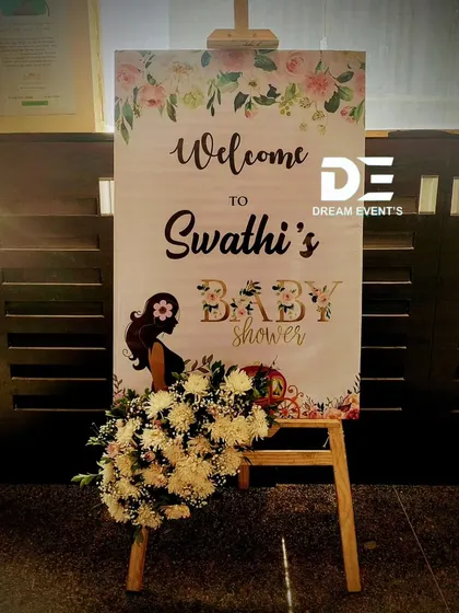 A chic, floral welcome sign for Swathi's baby shower. The design is modern and stylish, complemented by a fresh flower arrangement.