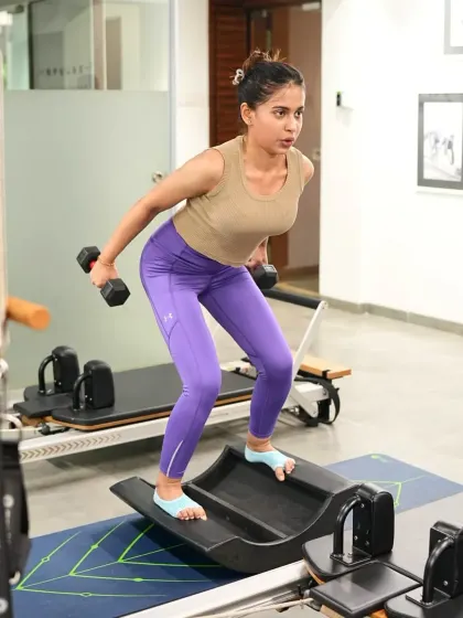 Ankita Bhatia demonstrates a bent over row, showcasing her focus and strong form. Under expert guidance, our clients learn to master every rep with precision.