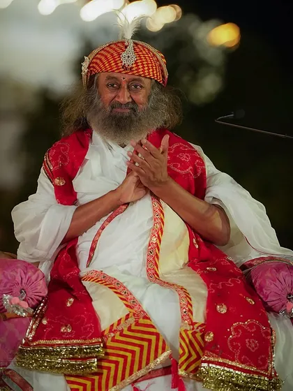 Gurudev, wearing a traditional Rajasthani turban, enjoys the cultural performances at the Rajasthan Mahotsav. The festival is a vibrant showcase of the state's rich heritage.