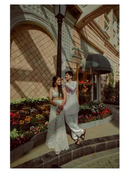 A playful and stylish full-length portrait of the couple, showcasing their personalities and coordinated outfits.