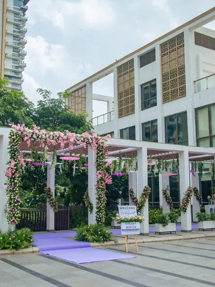 The outdoor entrance to the engagement venue, where the pergola is decorated with beautiful pink and white floral garlands.