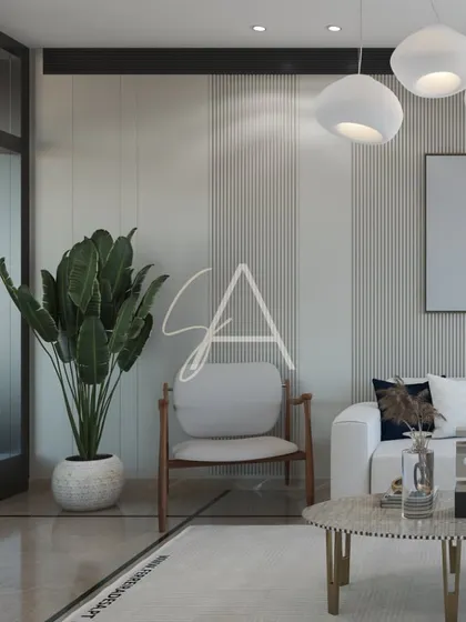 This lounge area uses vertical wall paneling and sculptural pendant lights to create a sense of height and modern sophistication. The large plant adds a touch of nature and freshness to the neutral space.