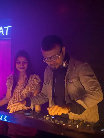 Sharing a moment with a fan at the DJ console. My sets are interactive, and I enjoy connecting with the audience.