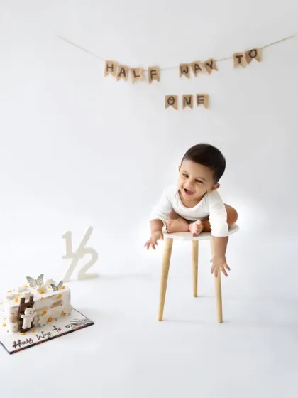 A playful moment during the six-month photoshoot. Capturing your baby's personality and new skills is the goal of every milestone session.