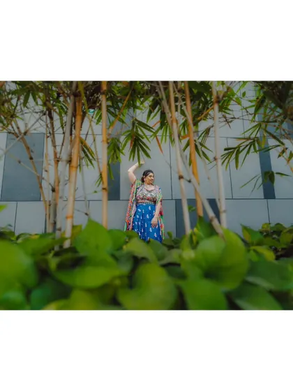 An artistic shot of the bride amidst bamboo plants, adding a touch of nature to the urban setting.