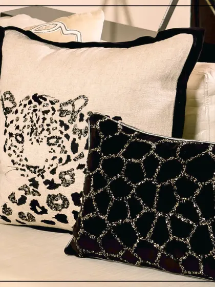 Step into the bold with this dramatic blend of fierce aesthetics and timeless sophistication. This close-up on a leopard-print cushion and a textured black cushion captures the luxurious details of the Wild Noir collection.