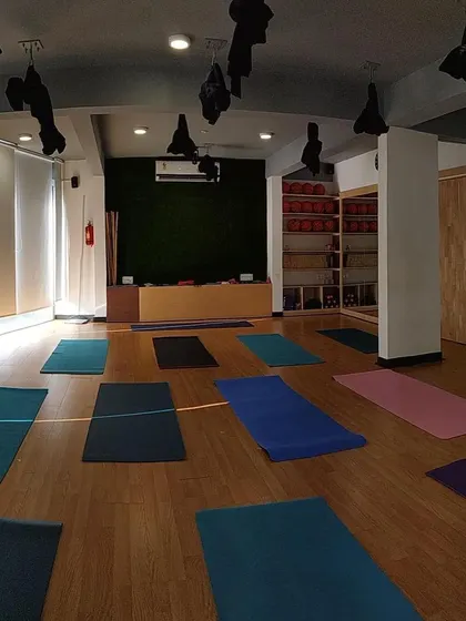 The studio awaits. An empty hall with mats laid out, ready for the energy and movement of our next class.