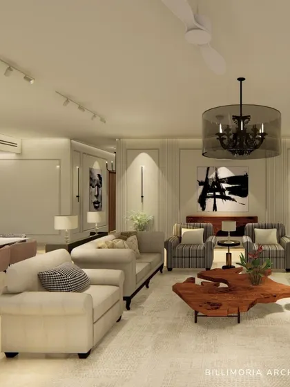 We designed this expansive living and dining area with a neutral color palette to create a calm and sophisticated environment. The space features plush sofas, a live-edge wooden coffee table, and carefully selected art to add character.