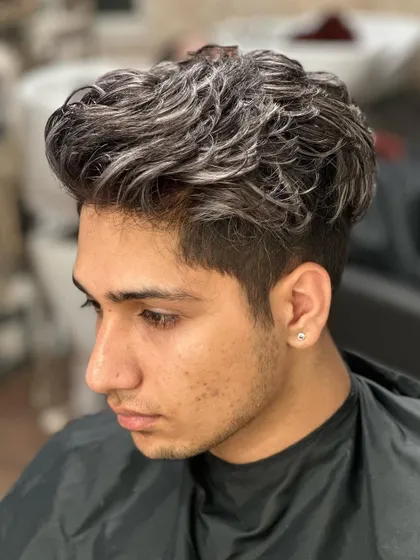 Crafting it silver. This is a stylish men's haircut with silver highlights for texture and dimension.