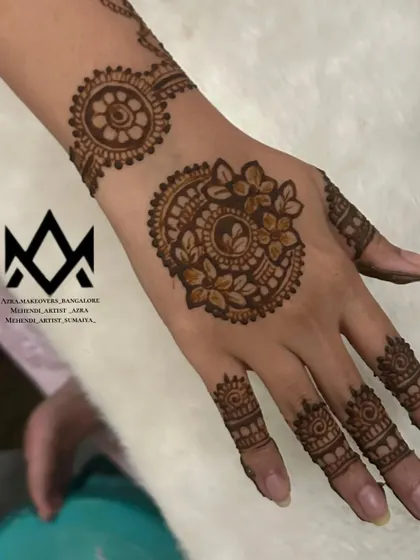This party mehendi features a stylish mandala on the back of the hand with a matching wristband and finger details.