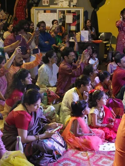 A packed house of enthusiastic parents and children, completely engaged in the music at our third-anniversary event. This is the community we have built together.