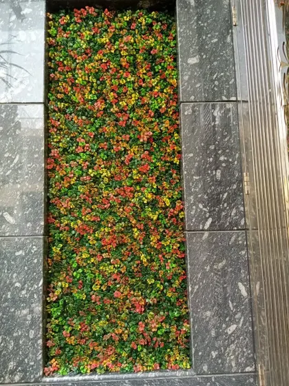 A close-up of the multi-colored artificial plants used for an indoor floor planter.