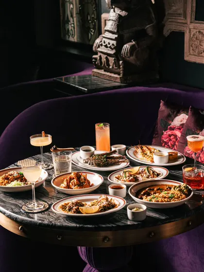 A full table spread at Ocho Bandra, showcasing the variety of their tapas-style offerings in a chic, dimly lit setting.