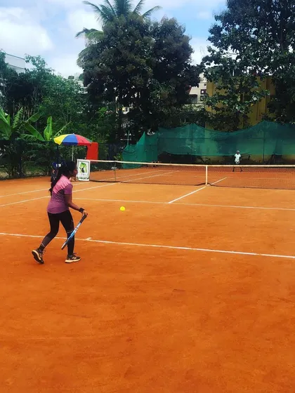 A junior girl returns a shot during a match in the Juniors and Men’s Open Tournament.