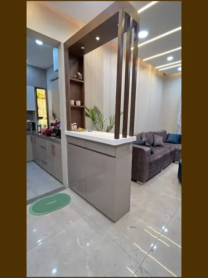 A full shot of the partition we designed for our Gurgaon site, which helps define the kitchen entrance while offering counter space and storage.