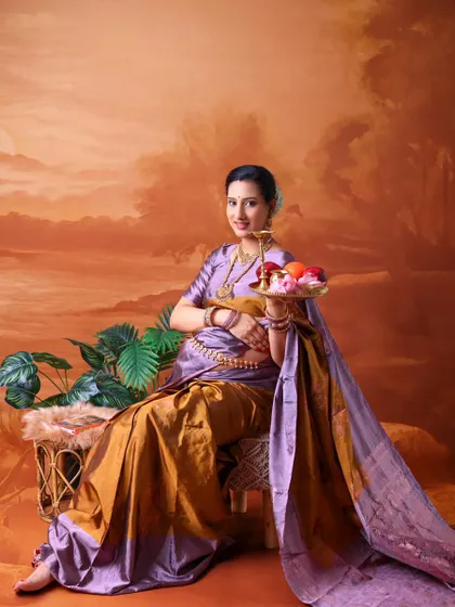 A classic portrait evoking Indian tradition and hospitality. The mom-to-be holds a tray of fruit, a symbol of abundance and life, while dressed in a beautiful saree.