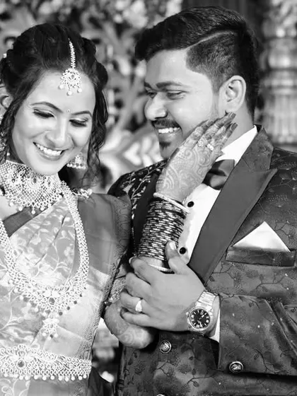 A beautiful black and white candid photo capturing a happy, unposed moment between the couple.