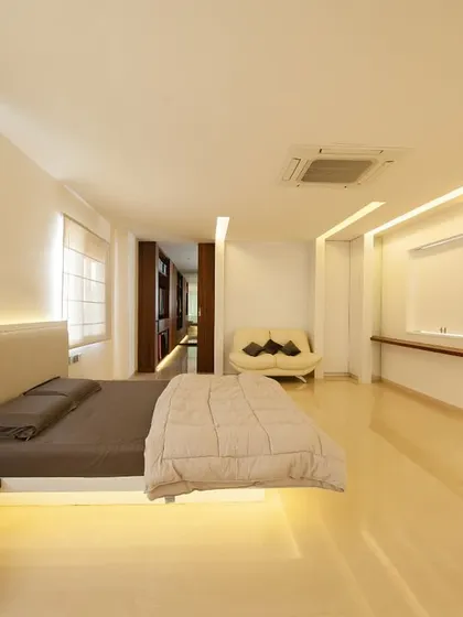 The master bedroom in the Neeti Residence. We use recessed and indirect lighting to create a soft ambiance, highlighting the clean lines of the floating bed and cantilevered shelves.
