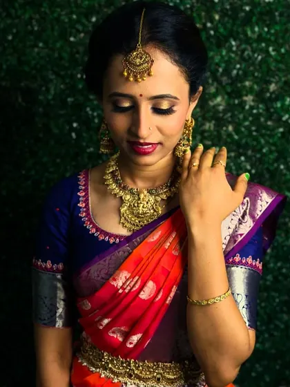 A trial makeup photo for my bride Chitra. Her look features a warm, golden eye and a bold red lip, perfectly complementing her traditional jewelry.
