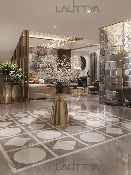This open-concept foyer design showcases how we create flow and elegance. The sleek marble floor with a geometric inlay leads the eye from the entrance towards the living area, with a sculptural glass partition adding a touch of modern artistry.