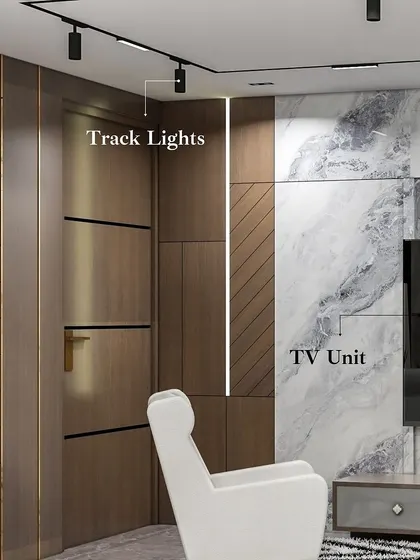 This detail shot highlights the different elements of the living room wall: the track lights for focused illumination, the sleek floating TV unit, and the textured wood and marble wall paneling that adds depth and luxury.