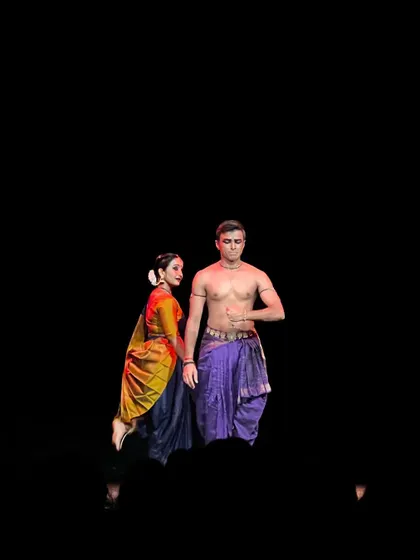A moment of stillness and focus during 'ĀBHA'. The contrast between light and dark creates a sense of drama and anticipation.