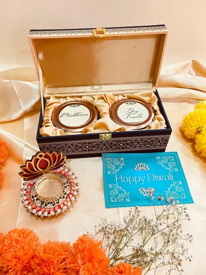An open view of the dark blue wooden box, containing two jars for makhana and dry fruits.
