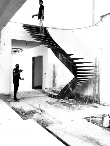 A dynamic shot of the staircase, with a person standing at the top, illustrating the journey it creates through the home.