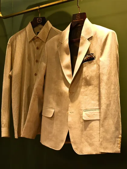 This lightweight linen jacket, paired with a striped shirt, is an example of relaxed sophistication. The clean lines and natural fabric make it a versatile piece, perfectly tailored for comfort and style.