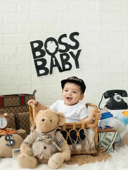 This Boss Baby is ready for business. Our themed shoots are all about capturing your child's personality, and this little one's happy expression says it all.