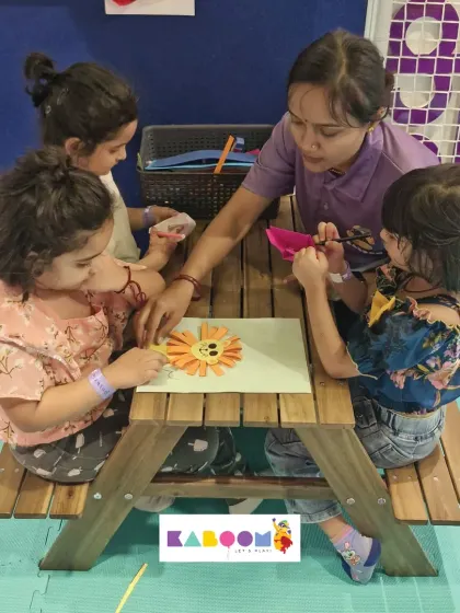 Our instructor provides one-on-one help to a group of young children as they create a vibrant paper sun. We ensure every child gets the attention they need to succeed.