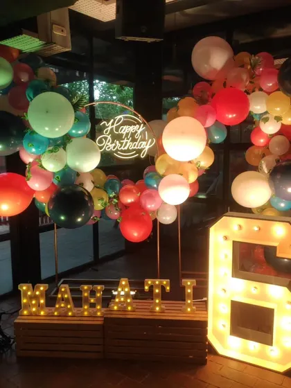 Another view of the festive decor, with colorful balloons and light-up marquee letters that create a perfect photo opportunity for the birthday child.
