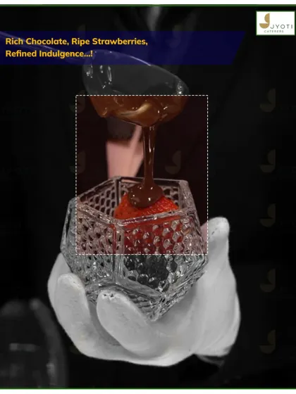 Refined indulgence in a glass. This dessert features ripe strawberries layered with rich chocolate sauce in an elegant crystal-cut glass.
