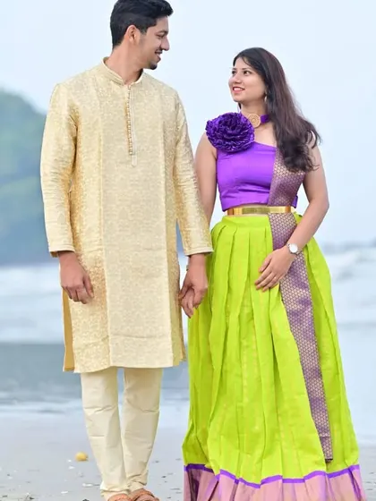 A beautiful pre-wedding shoot on the beach. The bride-to-be is wearing a modern lime green and purple lehenga, while he is in a classic cream kurta.