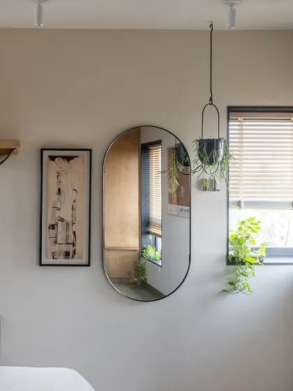 The guest bedroom features a Murphy bed that can be tucked away to transform the room into a multi-functional space for exercise or work. The main wall is an interactive play area for the clients' cats.