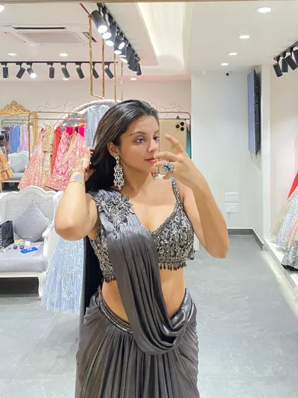 A close-up mirror selfie showcasing the intricate beadwork on the blouse of this grey pre-draped saree.