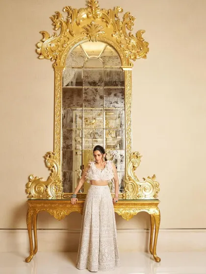 The full view of the Manish Malhotra chikankari lehenga, set against a stunning ornate mirror. The entire look is about celebrating in style.