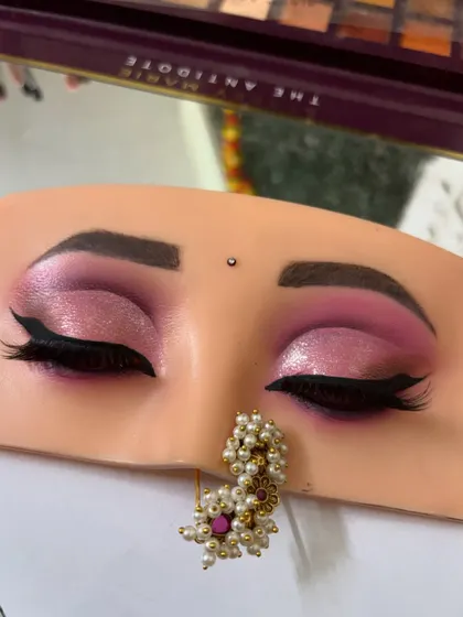 A close-up of the finished pink cut crease eye makeup, complete with a sharp winged liner. This look is perfect for sangeet or reception events.
