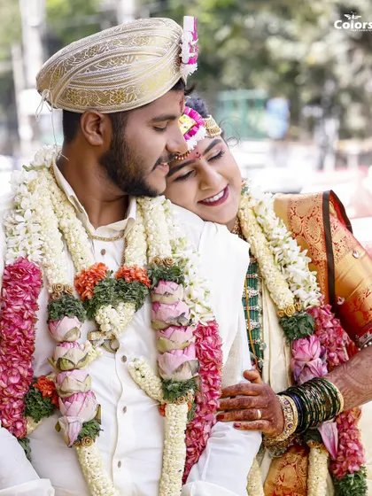 A tender moment between the bride and groom during their South Indian wedding ceremony. The bride rests her head on his shoulder, a quiet moment of comfort and love.