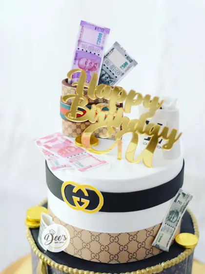 A closer look at the top tier, with its edible money and Gucci-inspired details.