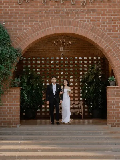The couple walking out from the arched entrance of 'The Secret Grove'. This shot feels like the beginning of their story, full of hope and elegance.