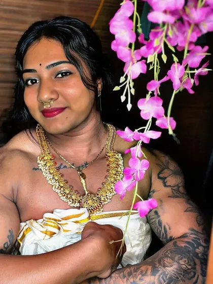 Another angle from my Kerala saree shoot. The soft flowers and traditional jewelry create a beautiful frame for a physique built on hard work and discipline.