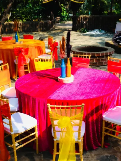 A view of the vibrant table settings, with bright pink and orange tablecloths that created a lively and energetic dining area.
