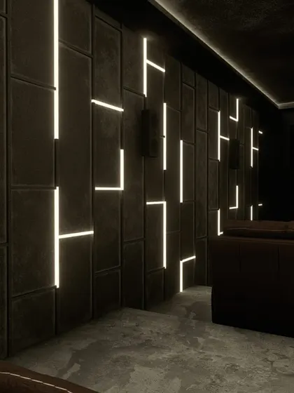 A stunning theater with geometric, backlit wall panels. This design is a perfect blend of art and acoustic engineering.