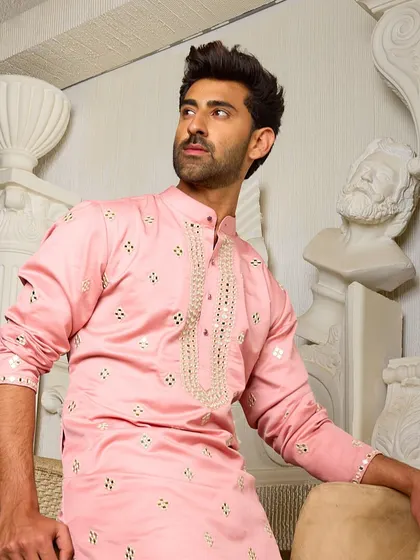 A relaxed pose in the pink kurta, showcasing its comfortable fit and elegant design. This piece is perfect for looking stylish with ease at any festive event.