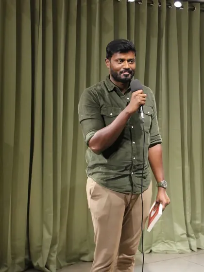 A performer takes the stage, ready to share their talent at our community meetup spot in Bengaluru.