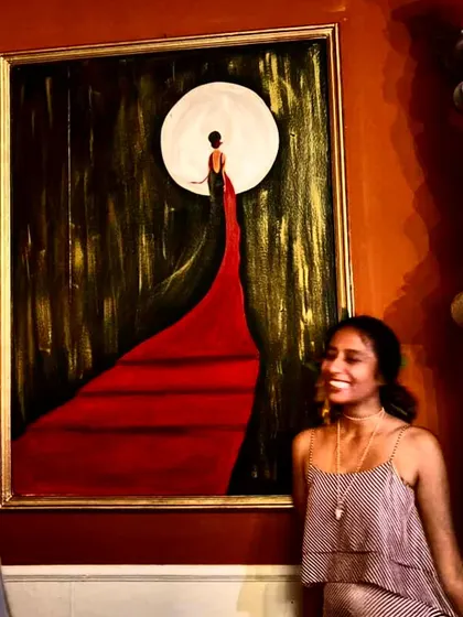 A moment of joy next to one of my clue paintings for the mystery party. This piece, "The Woman in Red," was a central part of the narrative, and my smile captures the fun of seeing my art come to life as part of an interactive story.