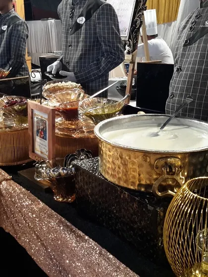 A close-up of a chaat station setup with sparkling table linen and hammered metal bowls, showing how even traditional food can be presented with flair.